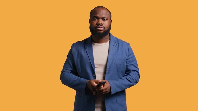 Sports fan watching in disbelief match broadcast after own team fails to score, ready to switch channel. Man frustrated with favorite club after committing blunder, studio background, camera B