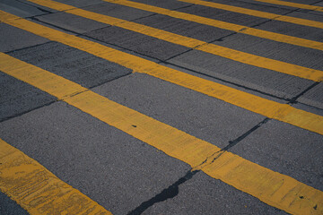 Empty Urban Crosswalk with Yellow Painted Lines in Hong Kong