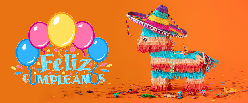Mexican pinata with sombrero hat and confetti on orange background