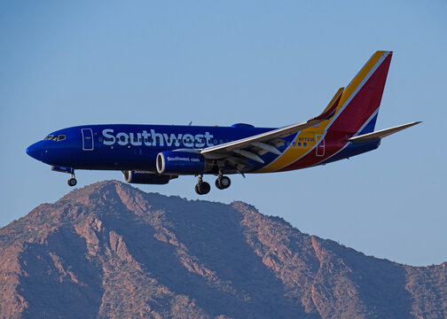 Phoenix Sky Harbor Airport 3-30-2024 Phoenix, AZ USA.. Southwest Airlines Boeing 737-700 N7723E sunset arrival for 26 at Sky Harbor Airport