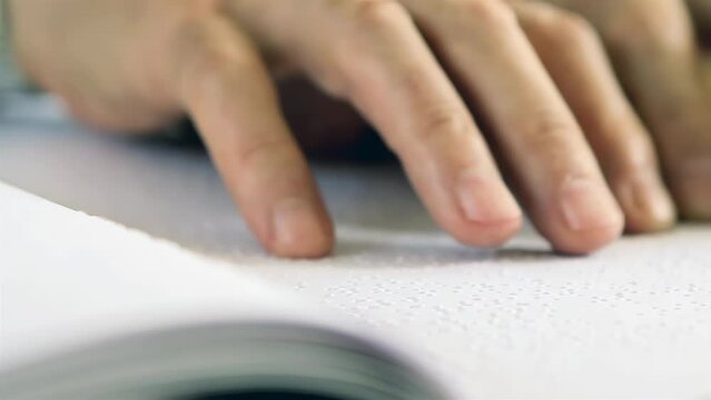 A Man Reading Braille Text with His Fingers. Close Up. 4K Resolution.