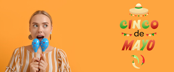 Pretty young woman with maracas on orange background