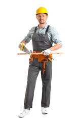 Male carpenter sawing wooden plank on white background