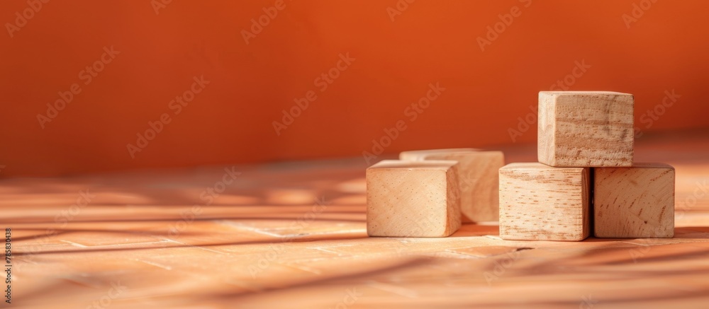 Poster wooden blocks of different sizes arranged in a stack on a flat surface