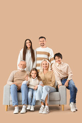 Big family sitting on sofa against beige background