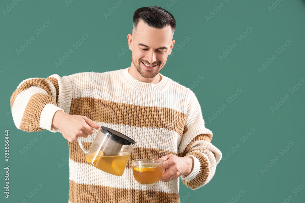 Sticker Young man with cup and teapot on green background