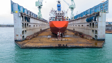 Oil tanker ship at dry dock concept maintenance service. working at dry dock. Insurance and...