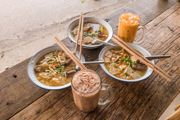Breakfast Steamed bread with colourful thai custard and Vietnamese Rice Noodles Soup ,Thai tea and brunch menu in Gopuek Godum local restaurant.Chiang Mai, Thailand.