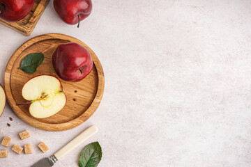 Wooden plate with fresh red apples on white background - 785841033