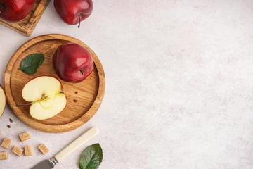 Fotobehang Wooden plate with fresh red apples on white background © Pixel-Shot