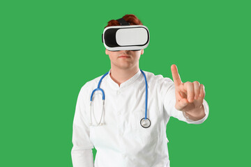 Male doctor using VR glasses on green background