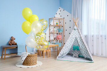 Interior of children's room with bunch of balloons and play tent