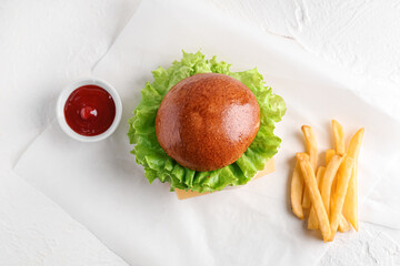 Tasty burger with french fries and ketchup on white grunge background