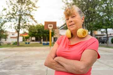 Portrait of senior woman smiling at outdoor playground with daylight