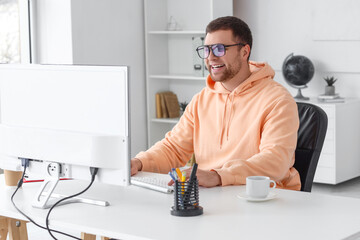 Portrait of male programmer working in office