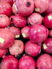 Batam, Indonesia - 16 April 2024: Fresh fruit. Piles of pomegranates are sold in neatly arranged supermarkets.