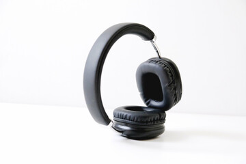 Black headphones on a white background. Stylish headphones, copy space