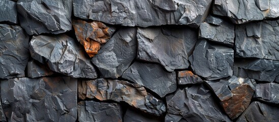 Detailed close up of a rugged rock surface featuring an intricately carved face sculpture