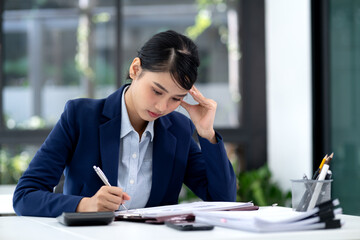 young business woman is giving serious thought to paperwork