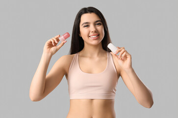 Happy smiling young woman with crystal deodorants on white background