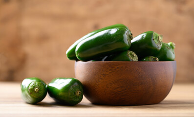 Fresh green Jalapeno chili in wooden bowl, Food ingredient
