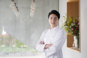 Image of a chef in an apron or a man working in the restaurant industry, arms crossed, changing jobs or hiring.