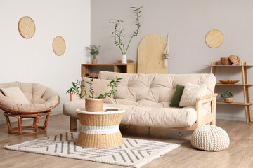 Interior of light living room with bamboo stems on coffee table and white sofa
