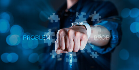 A man is punching a puzzle piece with the words problem on it