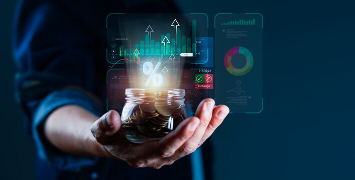 A person is holding a jar full of coins