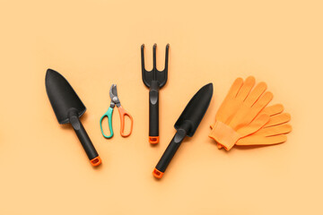 Tools for gardening on orange background. Top view