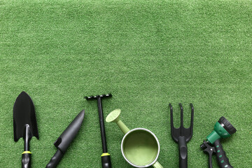 Gardening supplies on green grass background. Top view