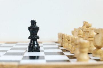 Leader, business strategy and planning concept. Chess king figure on chessboard facing black chess...