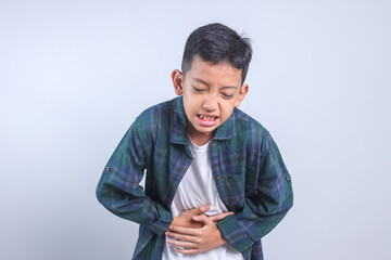 Young Boy Touching Belly Feeling Pain, Suffering Stomachache Isolated on White Background