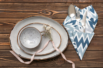 Beautiful table setting with gypsophila flowers on wooden background