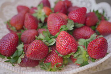 Red Strawberry in plastic bowl.