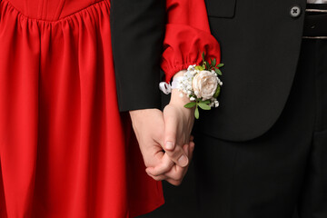 Beautiful couple dressed for prom holding hands, closeup © Pixel-Shot