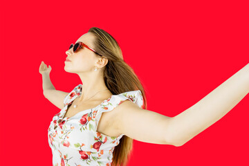 Happy woman with wide open arms isolated on red background