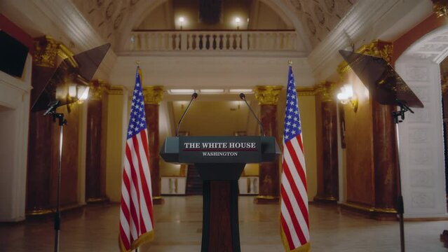 Wooden conference debate stand with microphones. Tribune for US President or congressman political speech in the White House. American flags in the background. Press campaign concept. Dolly Shot.