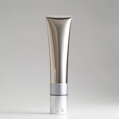 Sleek silver cosmetic tube for skincare product packaging with clean design aesthetic isolated on a gray backdrop