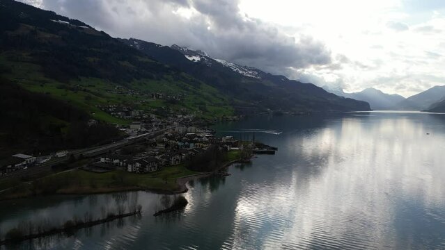 Profile view of clouds on top of hills of Walensee, Switzerland. RIverfront.