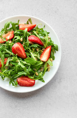Fresh Strawberry Arugula Salad With Pine Nuts Served on a Bright Day
