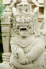 White Stone Deity Statue with Hands in Namaste Pose in Bali.