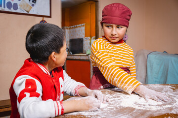 latin children siblings preparing flour to make bread - bakery concept