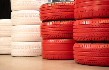 Stack of red and white car tires