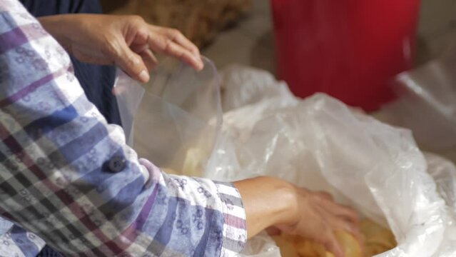 Cassava chips repackaged in plastic containers, taken for repackaging in small sizes. Side view.