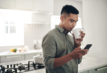 Man, drink and coffee in kitchen with smartphone for trending updates or popular topics on social...