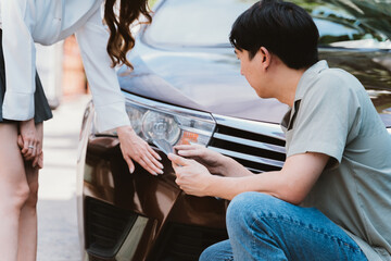 Car accident claim representative examining the accident with young Asian female driver talking with on the road