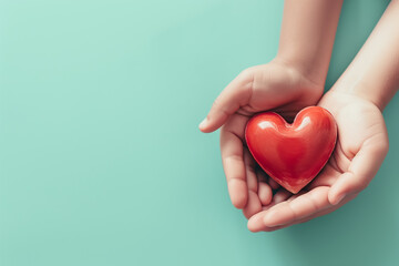 Obraz premium Hands cradle a glossy red heart isolated on pastel green background, symbolizing care, love, and protection in a gentle gesture
