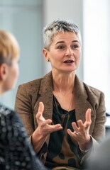 Professional Woman Engaged in an Animated Conversation During a Business Meeting