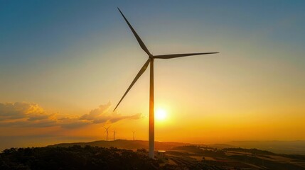 Fototapeta premium A single wind turbine generates renewable energy in a field during a vibrant sunset for sustainable power and green technology marketing campaigns.